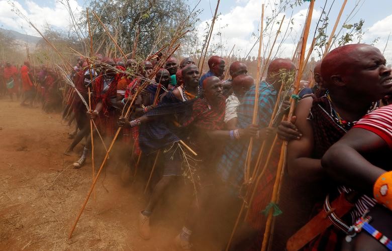 Maasai men of Matapato jostle to parade as they attend the Olng'esherr (meat-eating) passage ceremony to unite two age-sets; the older Ilpaamu and the younger Ilaitete into senior elder-hood as the final rite of passage, after the event was initially postponed due to the coronavirus outbreak, in the Maparasha hills of Kajiado, Kenya. REUTERS/Thomas Mukoya    